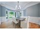 Bright dining room with bay window, white chairs, and a dark wood table at 552 Wyndham Ln, Marvin, NC 28173