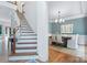 Bright dining room with hardwood floors, a large painting, and stairs on the left at 552 Wyndham Ln, Marvin, NC 28173