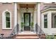 Elegant front entrance with a black door, sidelights, transom window, and decorative wreath at 552 Wyndham Ln, Marvin, NC 28173
