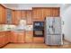 Kitchen featuring wooden cabinets, stainless steel appliances, and hardwood floors at 552 Wyndham Ln, Marvin, NC 28173