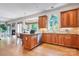 Spacious kitchen featuring hardwood floors, wooden cabinets, stainless steel dishwasher, and a sunlit breakfast nook at 552 Wyndham Ln, Marvin, NC 28173