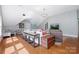 Well-lit living room with a large sectional, accent tables, and modern decor at 552 Wyndham Ln, Marvin, NC 28173