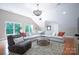 Bright, spacious living room with a large sectional couch, chandelier, and hardwood floors at 552 Wyndham Ln, Marvin, NC 28173