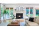 Cozy living room featuring a fireplace, hardwood floors, and views of the backyard at 552 Wyndham Ln, Marvin, NC 28173