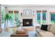 Bright living room featuring a fireplace, French doors with beautiful views, and stylish decor at 552 Wyndham Ln, Marvin, NC 28173