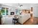 Bright living room with hardwood floors, fireplace, and adjacent open kitchen at 552 Wyndham Ln, Marvin, NC 28173