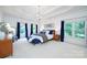Primary bedroom features a tray ceiling, chandelier lighting, large windows and elegant décor at 552 Wyndham Ln, Marvin, NC 28173