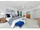 Bright primary bedroom features a tray ceiling, chandelier, blue accents, and hardwood furniture at 552 Wyndham Ln, Marvin, NC 28173