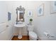 Elegant powder room with pedestal sink, decorative mirror, and stylish wall art at 552 Wyndham Ln, Marvin, NC 28173