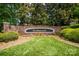 Elegant Wyndham Hall sign, framed by brick wall and vibrant, colorful flowerbed display at 552 Wyndham Ln, Marvin, NC 28173