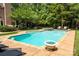 Backyard swimming pool has hot tub, lounge chairs and lush green trees, ideal for relaxing or hosting gatherings at 552 Wyndham Ln, Marvin, NC 28173