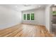 An empty bedroom boasting recessed lighting, hardwood floors, and large windows providing ample natural light at 5601 Robinhood Rd, Charlotte, NC 28211