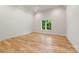 Bright bedroom with hardwood floors and a large window overlooking the greenery outside at 5601 Robinhood Rd, Charlotte, NC 28211