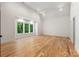 Spacious bedroom with hardwood floors, recessed lights and a large window framing a view of trees at 5601 Robinhood Rd, Charlotte, NC 28211
