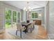 Sunlit dining room featuring modern lighting and decorative wallpaper at 5601 Robinhood Rd, Charlotte, NC 28211