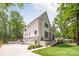 Spacious home with a three-car garage and well-manicured lawn is surrounded by mature trees at 5601 Robinhood Rd, Charlotte, NC 28211