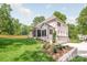 Beautiful white brick home with manicured lawn, rear screened porch, and an attached garage at 5601 Robinhood Rd, Charlotte, NC 28211