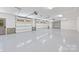 Spacious three car garage with epoxy flooring, three doors, and ample room for vehicles at 5601 Robinhood Rd, Charlotte, NC 28211