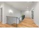 Upstairs hallway with hardwood floors, recessed lighting, and white trim at 5601 Robinhood Rd, Charlotte, NC 28211