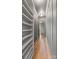 Long hallway with custom wood paneling, hardwood floors, custom shelves, and a view to the exterior at 5601 Robinhood Rd, Charlotte, NC 28211