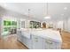 Bright, open kitchen featuring a farmhouse sink and hardwood floors at 5601 Robinhood Rd, Charlotte, NC 28211