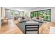 Spacious living room with kitchen, large windows, comfortable seating and hardwood floors at 5601 Robinhood Rd, Charlotte, NC 28211