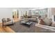 Open living area with a large sofa, a view to the kitchen, and hardwood floors at 5601 Robinhood Rd, Charlotte, NC 28211