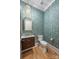 Stylish powder room with patterned wallpaper, designer vanity, and gold fixtures at 5601 Robinhood Rd, Charlotte, NC 28211