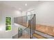 Bright foyer featuring hardwood floors, black iron railing, and natural light from a large window at 5601 Robinhood Rd, Charlotte, NC 28211