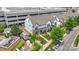 An aerial view of a two-story townhome with lush greenery, surrounded by cars and a parking garage at 5946 Ardrey Kell Rd, Charlotte, NC 28277