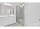 Clean, white bathroom featuring a glass-enclosed shower and sleek vanity with ample counter space at 5946 Ardrey Kell Rd, Charlotte, NC 28277