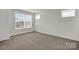 Neutral bedroom featuring a large window for natural light and plush carpeting at 5946 Ardrey Kell Rd, Charlotte, NC 28277