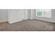 Spacious bedroom with neutral tones, plush carpet and a window providing natural light at 5946 Ardrey Kell Rd, Charlotte, NC 28277