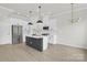 This spacious kitchen boasts white cabinetry, stainless steel appliances, an island and elegant pendant lighting at 5946 Ardrey Kell Rd, Charlotte, NC 28277