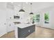 Well-lit kitchen features white cabinets, stainless steel appliances, a stylish island, and a window with a backyard view at 5946 Ardrey Kell Rd, Charlotte, NC 28277
