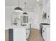 Bright kitchen featuring white cabinets, stainless steel appliances, an island with modern pendant lights, and an open layout at 5946 Ardrey Kell Rd, Charlotte, NC 28277