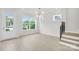 Bright room with large windows bringing the outdoors in, near stairs to the upper level at 5946 Ardrey Kell Rd, Charlotte, NC 28277