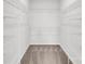 Empty walk-in closet with carpeted floor and multiple shelves for organization at 5946 Ardrey Kell Rd, Charlotte, NC 28277