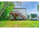 Expansive backyard showcasing a wooden deck with stairs, complemented by a lush green lawn at 600 S Cline Ave, Newton, NC 28658