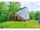 Expansive backyard showcasing a wooden deck with stairs, complemented by a lush green lawn at 600 S Cline Ave, Newton, NC 28658