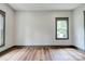 Bright bedroom with hardwood floors and two windows showcasing natural light at 600 S Cline Ave, Newton, NC 28658