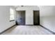 Bedroom featuring a window and two dark-stained doors, complemented by neutral walls and carpet at 600 S Cline Ave, Newton, NC 28658