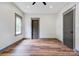 Bright bedroom features hardwood flooring, gray trim, a modern ceiling fan, and two entry doors at 600 S Cline Ave, Newton, NC 28658