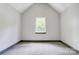 Neutral carpet and walls provide a versatile backdrop in this bedroom with a central window at 600 S Cline Ave, Newton, NC 28658