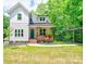 Charming two-story home featuring a covered porch, manicured lawn, and convenient carport at 600 S Cline Ave, Newton, NC 28658
