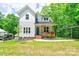 Charming two-story home featuring a covered porch, manicured lawn, and lush greenery at 600 S Cline Ave, Newton, NC 28658