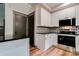 Lovely kitchen with stainless steel appliances, black countertops, stylish backsplash, and hardwood floors at 600 S Cline Ave, Newton, NC 28658
