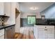 Cozy eat-in kitchen offers island, hardwood flooring, stainless steel appliances, and living area access at 600 S Cline Ave, Newton, NC 28658