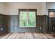 Bright living room with wainscoting, natural light, and wood-look flooring at 600 S Cline Ave, Newton, NC 28658