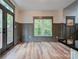 Open-concept living area featuring wood floors, wainscoting, and access to the outdoor deck at 600 S Cline Ave, Newton, NC 28658